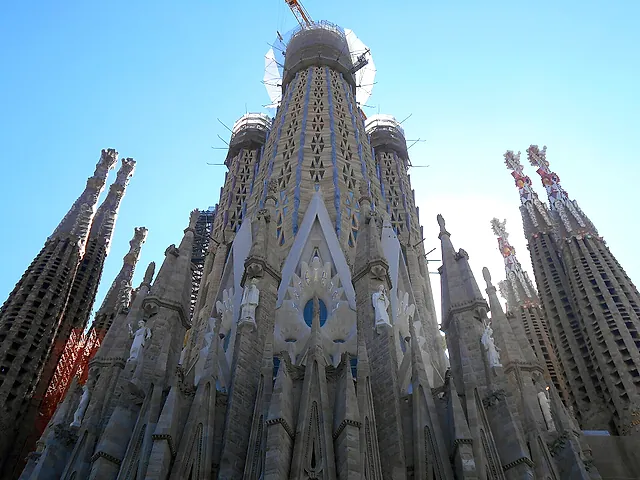 Low-angle view of the central tower and the surrounding pinnacled towers of the basilica against a blue sky